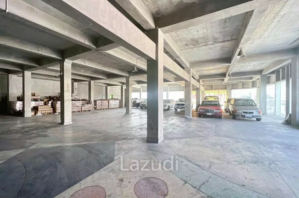 Prime Corner Showroom for Car Dealership or Business with Heavy-Duty Lift and Ample Parking