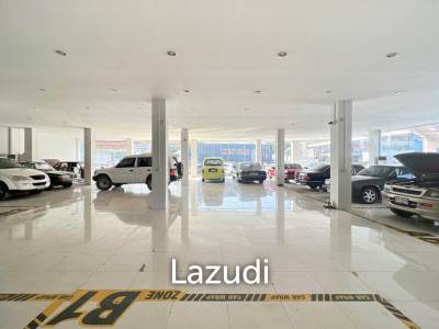 Prime Corner Showroom for Car Dealership or Business with Heavy-Duty Lift and Ample Parking