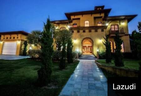 Exterior view of a large two-story house with illuminated entrance