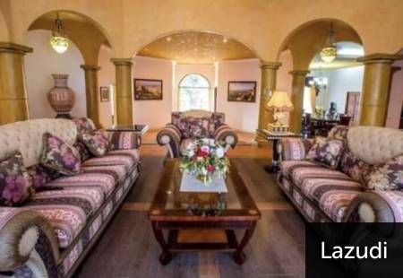 Living room with patterned sofas and a central wooden coffee table