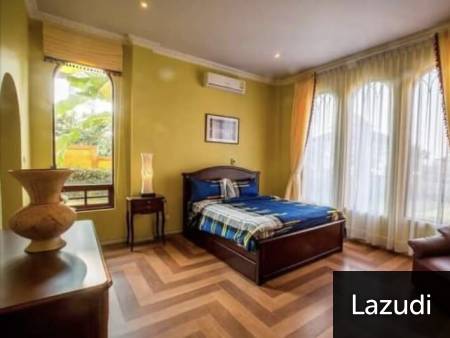 Bedroom with large windows and wooden flooring