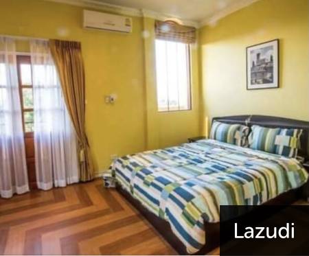 Bedroom with large bed, wooden floor, and air conditioning