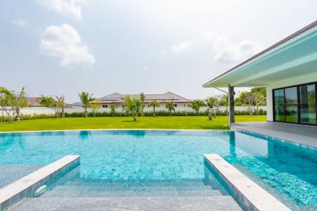 Outdoor swimming pool next to a modern residential building