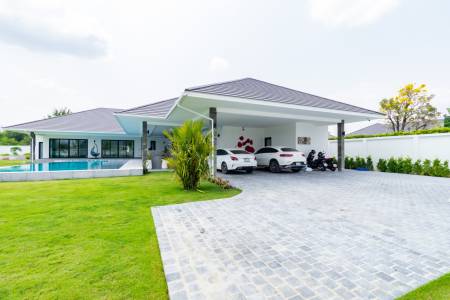 Modern single-story house with carport and landscaped lawn