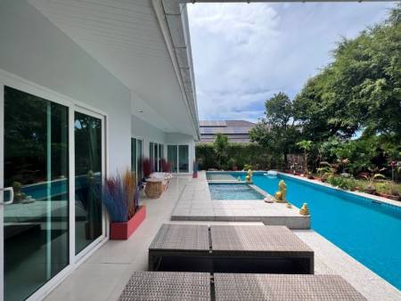 Outdoor pool area with sun loungers and poolside seating