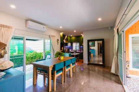 Dining area with table and chairs next to sliding glass doors