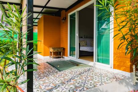 Outdoor patio area with sliding glass doors leading to bedroom