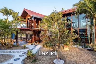 Glass-walled restaurant with gardens in Cha Am