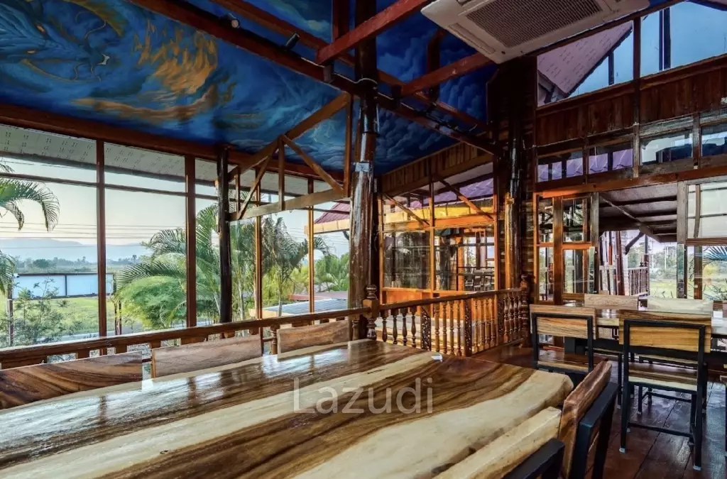 Glass-walled restaurant with gardens in Cha Am