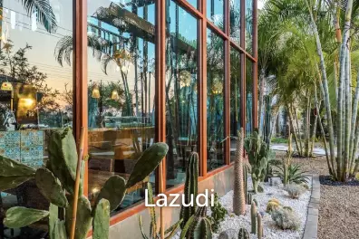 Glass-walled restaurant with gardens in Cha Am