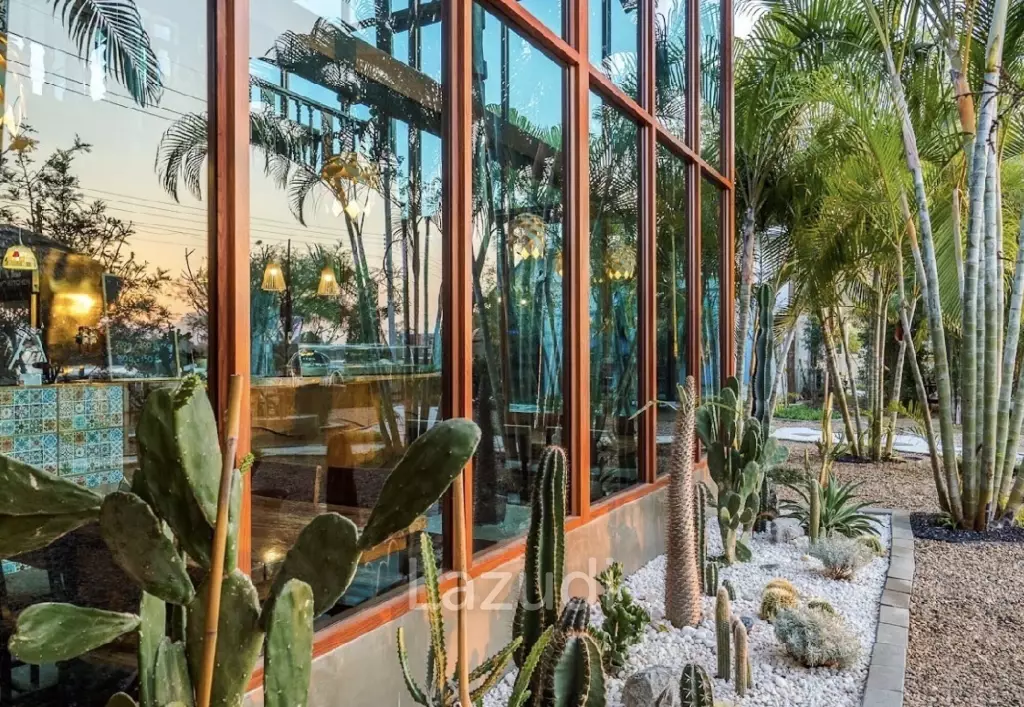 Glass-walled restaurant with gardens in Cha Am