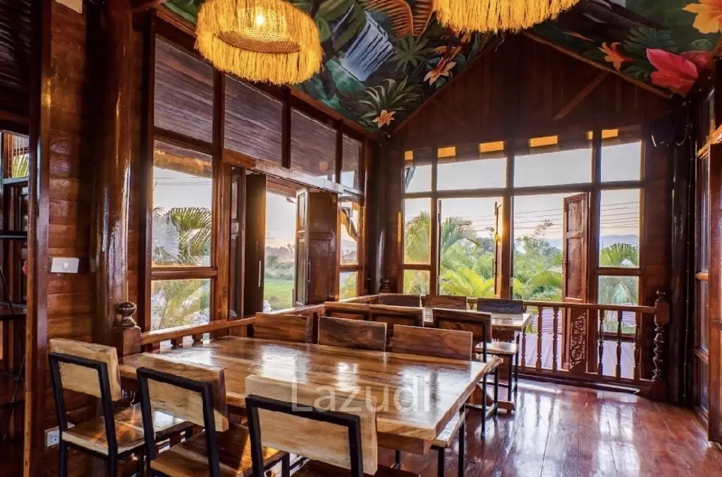 Glass-walled restaurant with gardens in Cha Am
